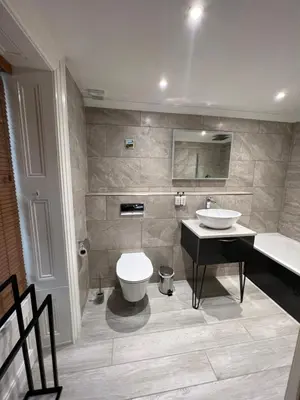 a bathroom with a sink and a toilet and a counter at The Ship Inn - Winner Best Hotel Experience 2024 Visit Scotland in Gatehouse of Fleet