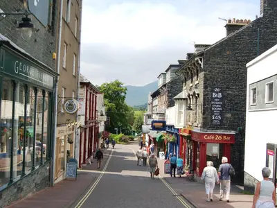 a group of people walking down a street in a town at 5 Balmoral House in Keswick
