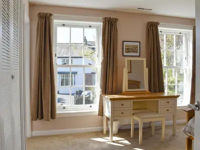 a bedroom with a desk and a window at Oak Apple House in Keswick