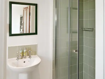 a bathroom with a sink and a shower at Shore Cottage in Carsluith