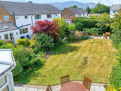 a view of a garden from the balcony of a house at Heatherside in Portinscale