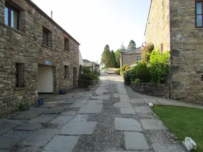 a stone walkway next to a stone building at Fell View in Troutbeck
