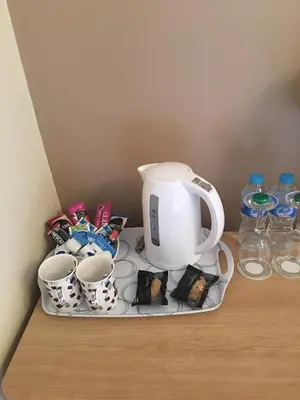 a tea kettle and cups on a tray on a table at Thornbank House in Stranraer