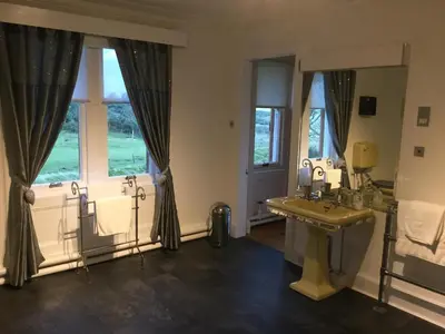 a bathroom with a sink and a large window at Sandhill House in Troon
