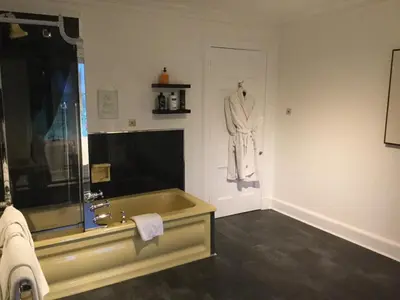 a bathroom with a sink and a robe hanging on the wall at Sandhill House in Troon