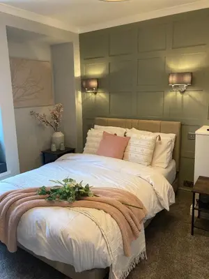 a bedroom with a large bed with flowers on it at Abbey Court Guest House in Carlisle