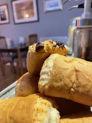 a pile of pastries on a plate on a table at Glendale Guest House in Keswick