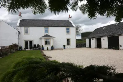 a large white house with a large driveway at Crofthead Farm House in Tarbolton