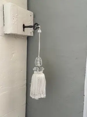 a glass light hanging from a switch on a wall at Ann's Hill in Cockermouth