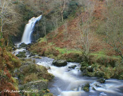 a waterfall in the middle of a river at Crailloch Croft Cottages in Stranraer