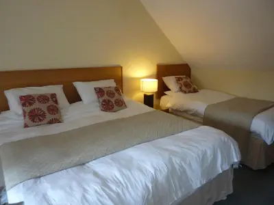 a hotel room with two beds and a lamp at The Douglas Hotel in Langholm