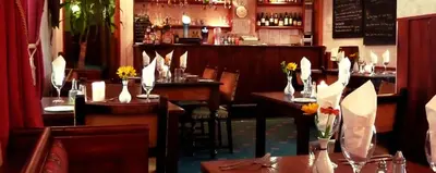 a restaurant with tables and chairs and a bar at The Douglas Hotel in Langholm