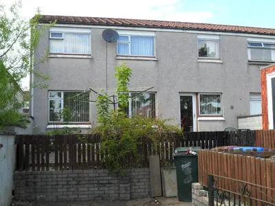 a house with a fence in front of it at House for Groups & Contractors Kilmarnock in Kilmarnock