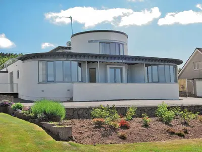 a large white house with a garden in front of it at Island View in Dunure