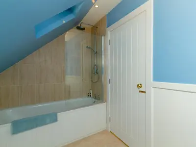 a bathroom with a tub and a shower at Two The Stables in Dalrymple