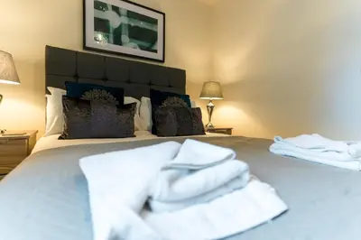 a bedroom with a bed with white towels on it at Church View Irene Court Cockermouth in Cockermouth
