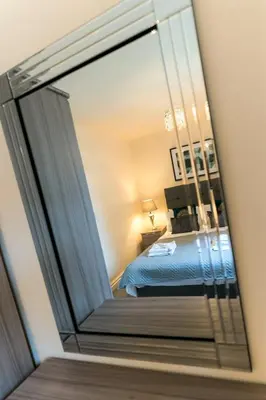 a mirror reflection of a bed in a bedroom at Church View Irene Court Cockermouth in Cockermouth