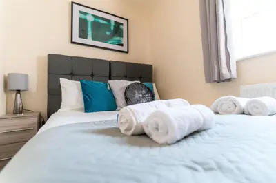 a bedroom with two beds with towels on them at Irene Court Cockermouth in Cockermouth