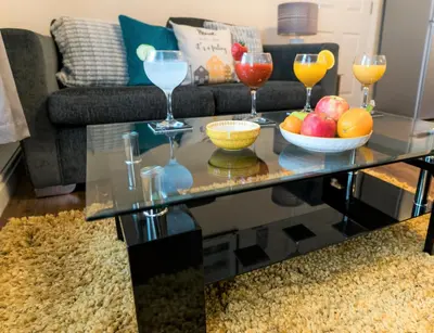 a coffee table with wine glasses and fruit on it at Irene Court Cockermouth in Cockermouth