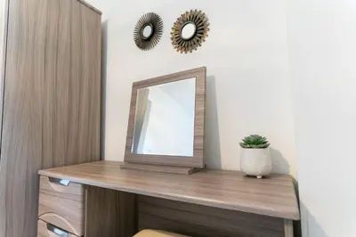 a mirror on a wooden shelf in a room at Irene Court Cockermouth in Cockermouth