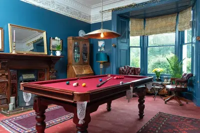 a living room with a pool table in it at Moffat Independent Hostel in Moffat