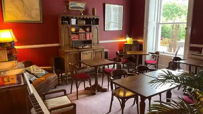 a restaurant with tables and chairs in a room at Moffat Independent Hostel in Moffat