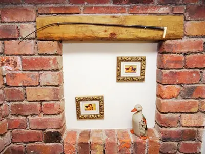 a figurine of a bird sitting on a brick wall at Saddleback Barn in Penrith