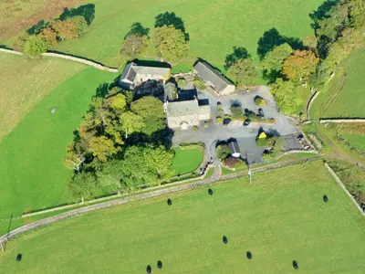 an aerial view of a large house in a field at Stable Barn in Penrith