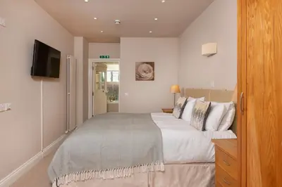 a bedroom with a large bed and a television at Bannerdale in Penrith