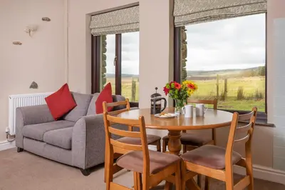 a living room with a table and a couch at Grisdale View in Penrith