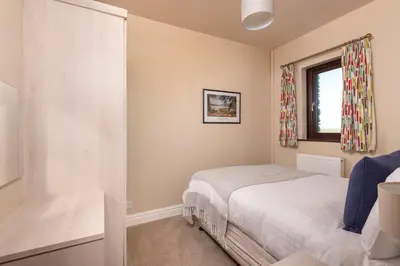 a bedroom with a bed and a window at Howe End in Mungrisdale