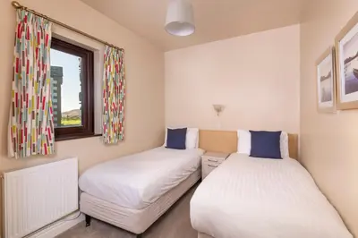 two beds in a room with a window at Howe End in Mungrisdale