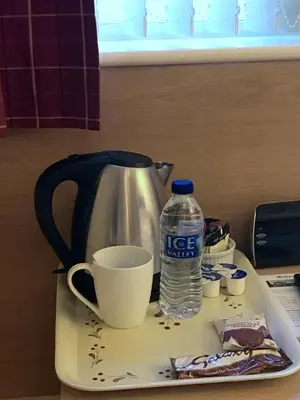 a coffee maker and a bottle of water on a tray at Glenlossie Guest House in Dumfries