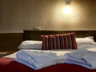 a bed with two pillows on top of it at Glenlossie Guest House in Dumfries
