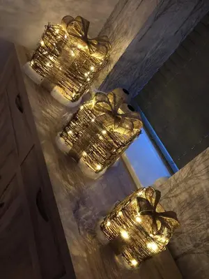 a group of five gold chandeliers with lights at Ancrum House in Gretna Green