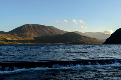 a large body of water with mountains in the background at The Mansion in Whitehaven