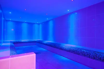 a room with blue and purple lights and a bench at The Daffodil Hotel & Spa in Grasmere
