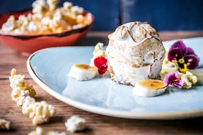 a plate with a ice cream dessert on a table at The Daffodil Hotel & Spa in Grasmere