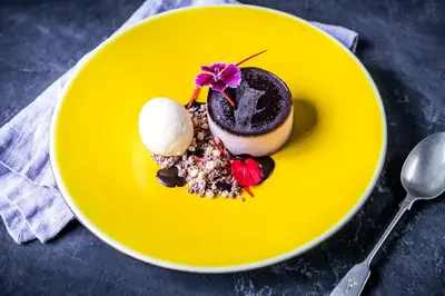 a yellow plate with a dessert on a table at The Daffodil Hotel & Spa in Grasmere