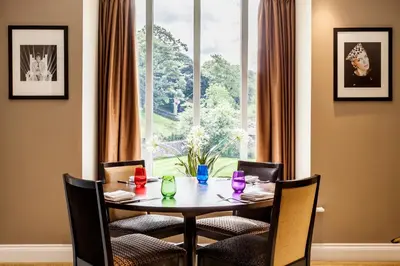 a dining room with a table and chairs and a window at The Daffodil Hotel & Spa in Grasmere
