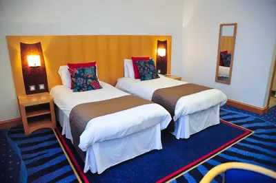 a room with two beds in a hotel room at The Park Hotel in Kilmarnock