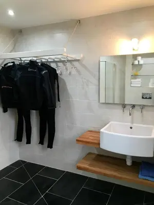 a bathroom with a sink and a mirror at Airds Bay Luxury Beach House in Gatehouse of Fleet