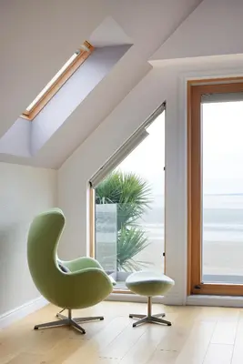 a green chair and a stool in a room with a window at Airds Bay Luxury Beach House in Gatehouse of Fleet