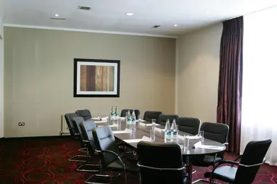 a conference room with a long table and chairs at Riverside Lodge Hotel in Irvine