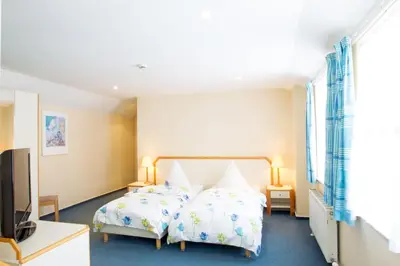 a bedroom with a bed and a flat screen tv at The Penta in Douglas