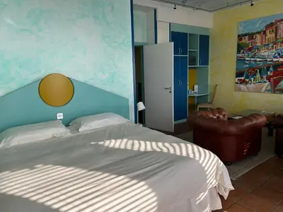 a bedroom with a bed and a chair at The Penta in Douglas