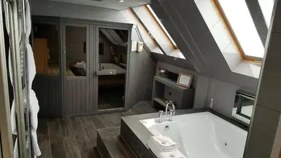 a bathroom with a bath tub and a sink at The Gailes Hotel & Spa in Irvine