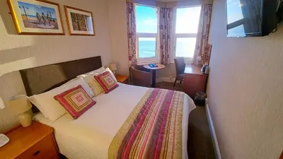 a hotel room with a bed and a window at The Hydro Hotel in Douglas