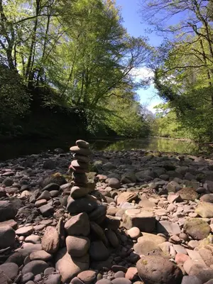 a stack of rocks on a rocky river at Broomhills Farm River Eco Pods in Carlisle