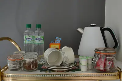 a table with bottles of water and jars on it at Briar Brae Bed & Breakfast in Stranraer